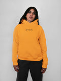 Person wearing a yellow hoodie with 'blk top Kope' branding on a plain background