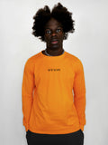 Person wearing a yellow long-sleeve shirt with a logo on a white background