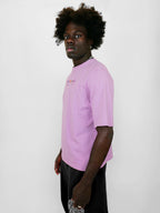 Person wearing a blush t-shirt with text on a white background