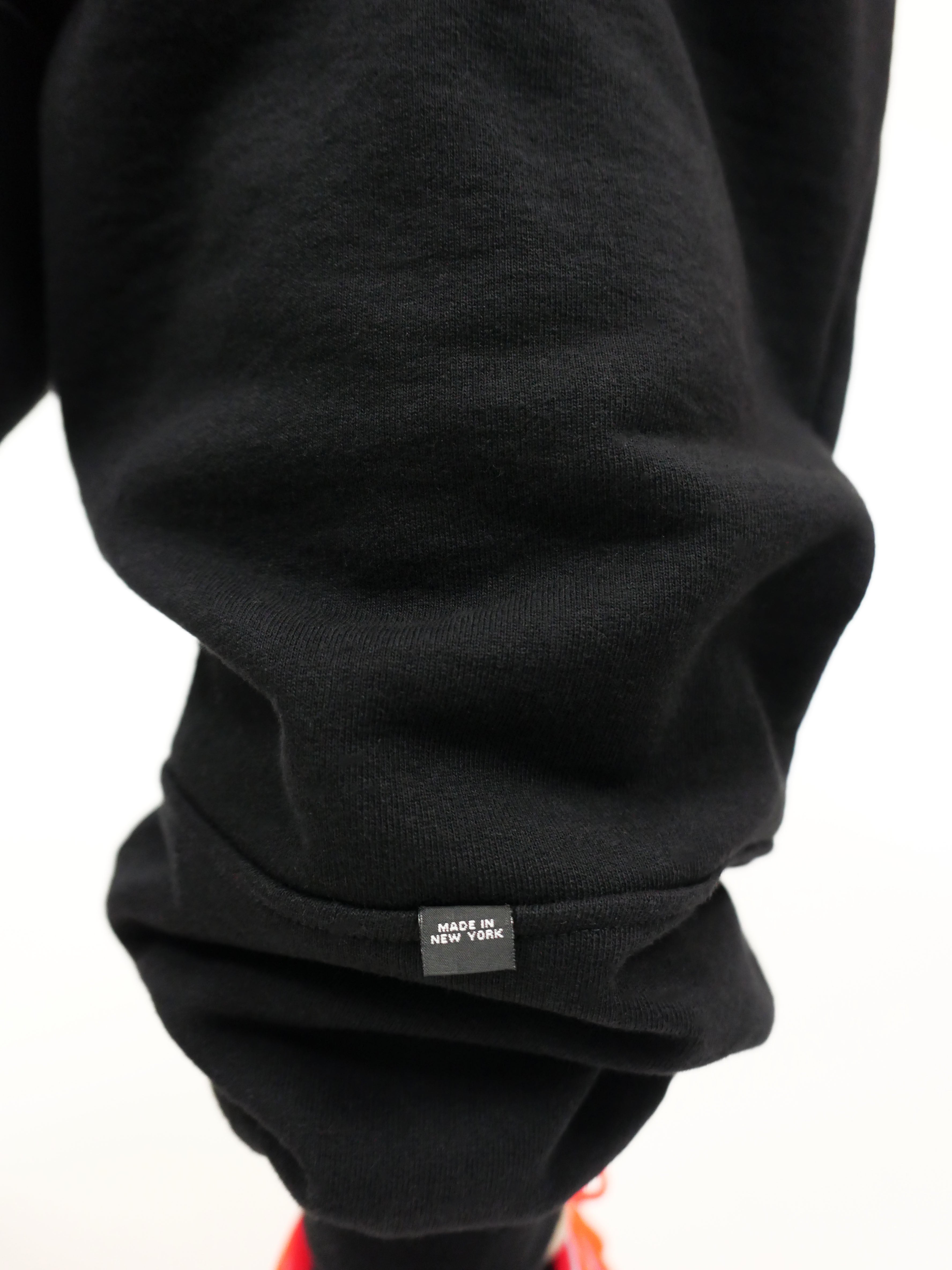 Black sweatshirt with a 'Made in New York" label on a white background