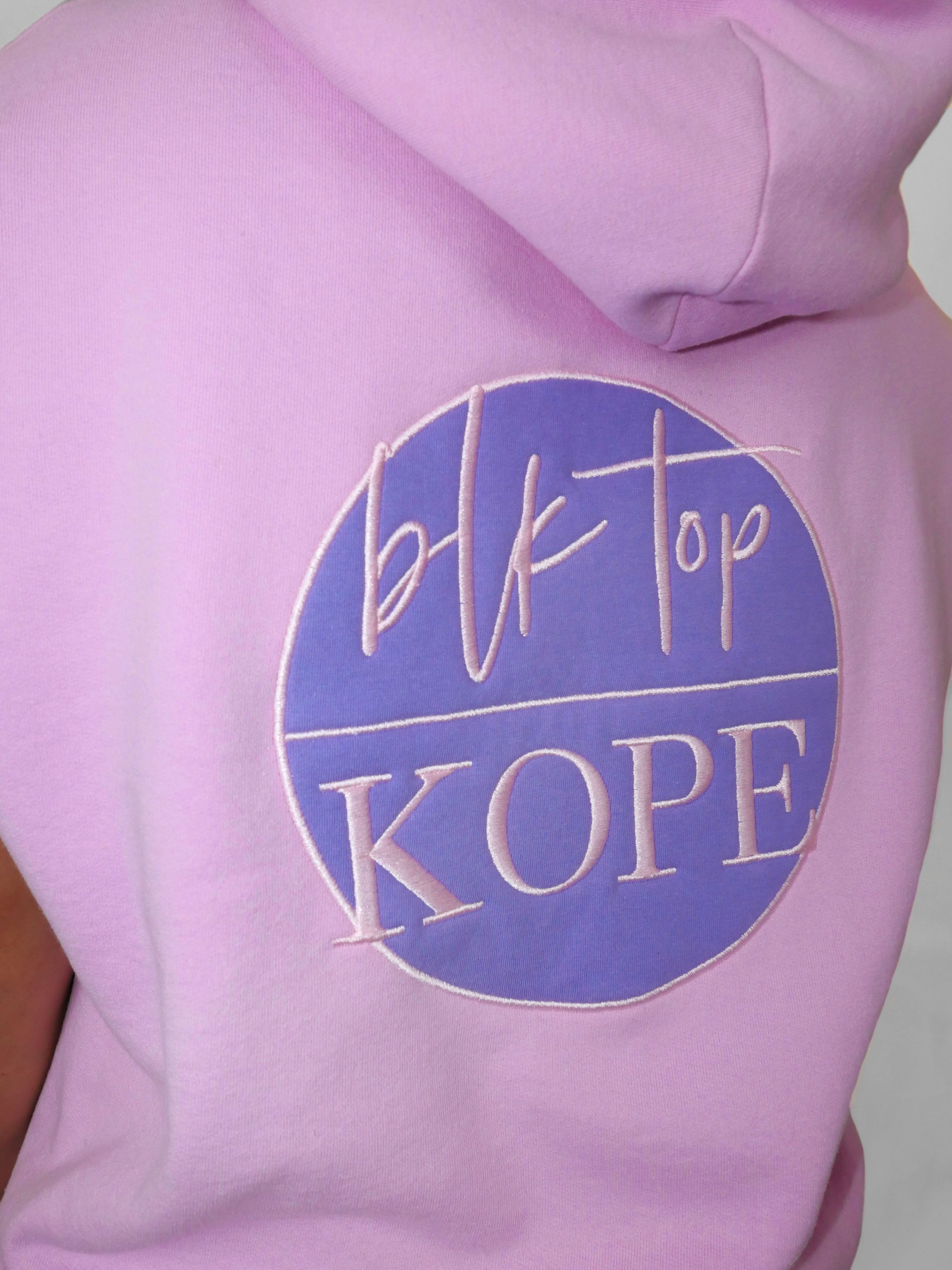 Blush sleeveless hoodie with 'blk top Kope' logo on a plain background