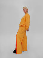 Person wearing a yellow outfit with a white background