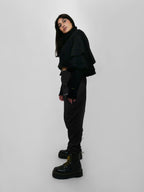 Person wearing a black outfit with a white background