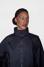 person wearing black track jacket with closed zipper