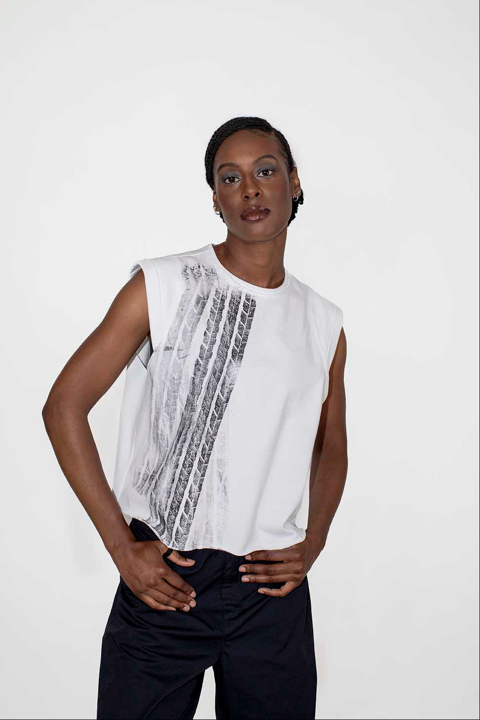 person wearing white sleeveless top and black loose pants