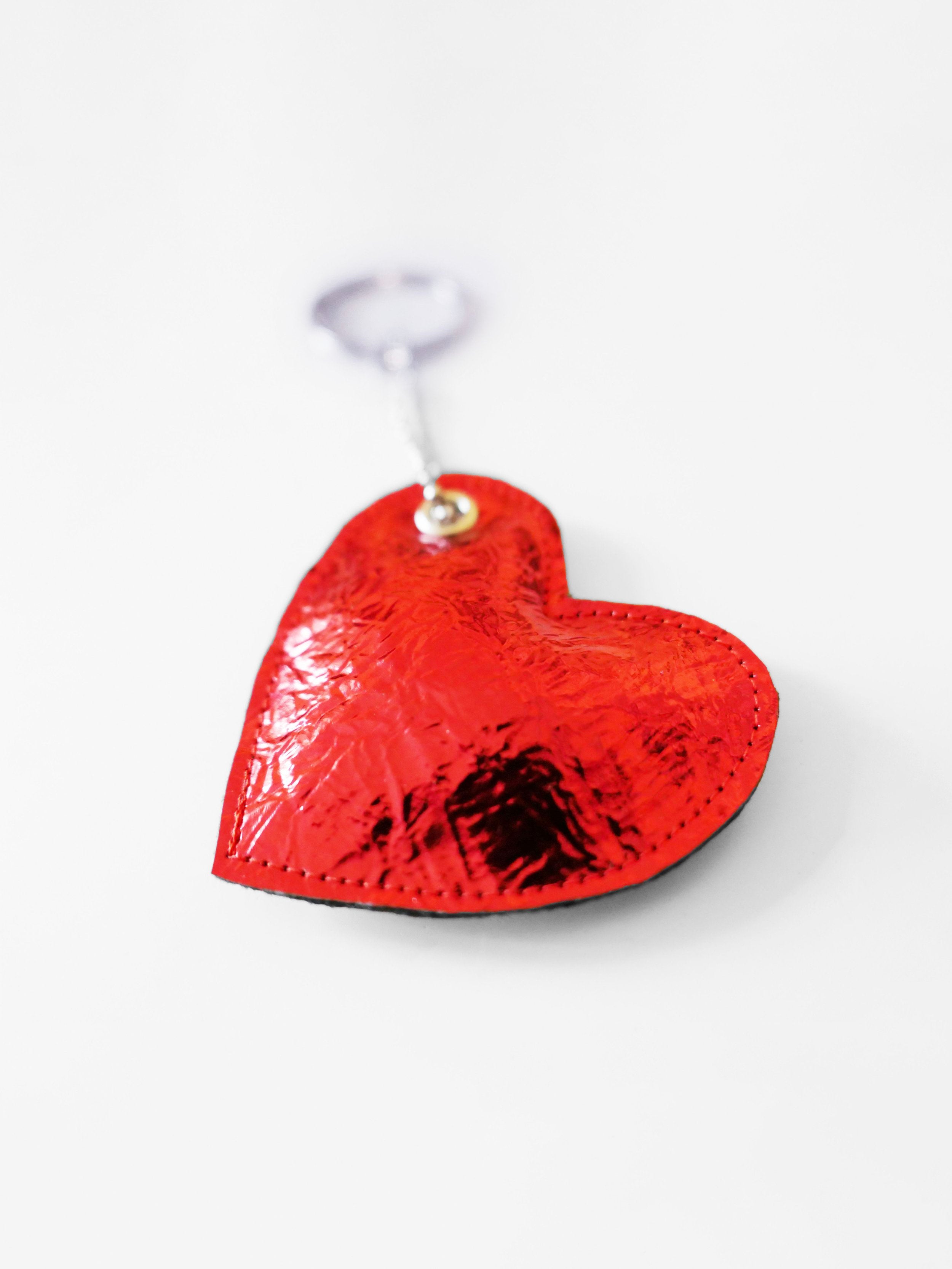 red heart-shaped keychain on a white background